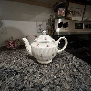 white floral vintage teapot made in england and is a collectible
